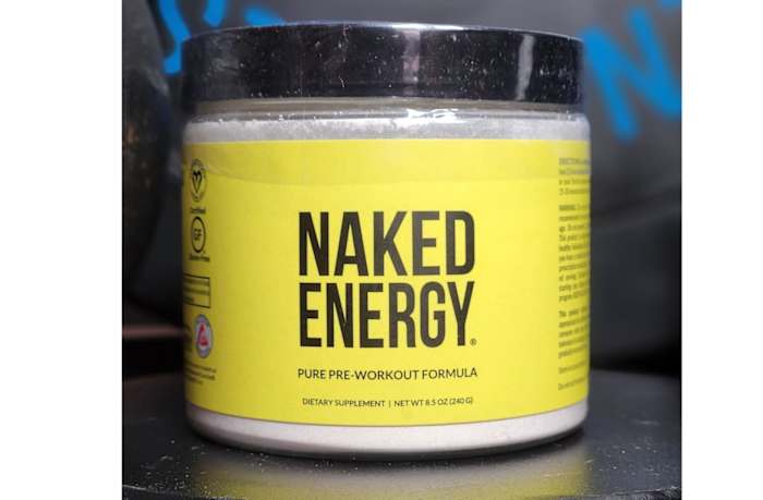A yellow and black container of Naked Energy pre-workout formula